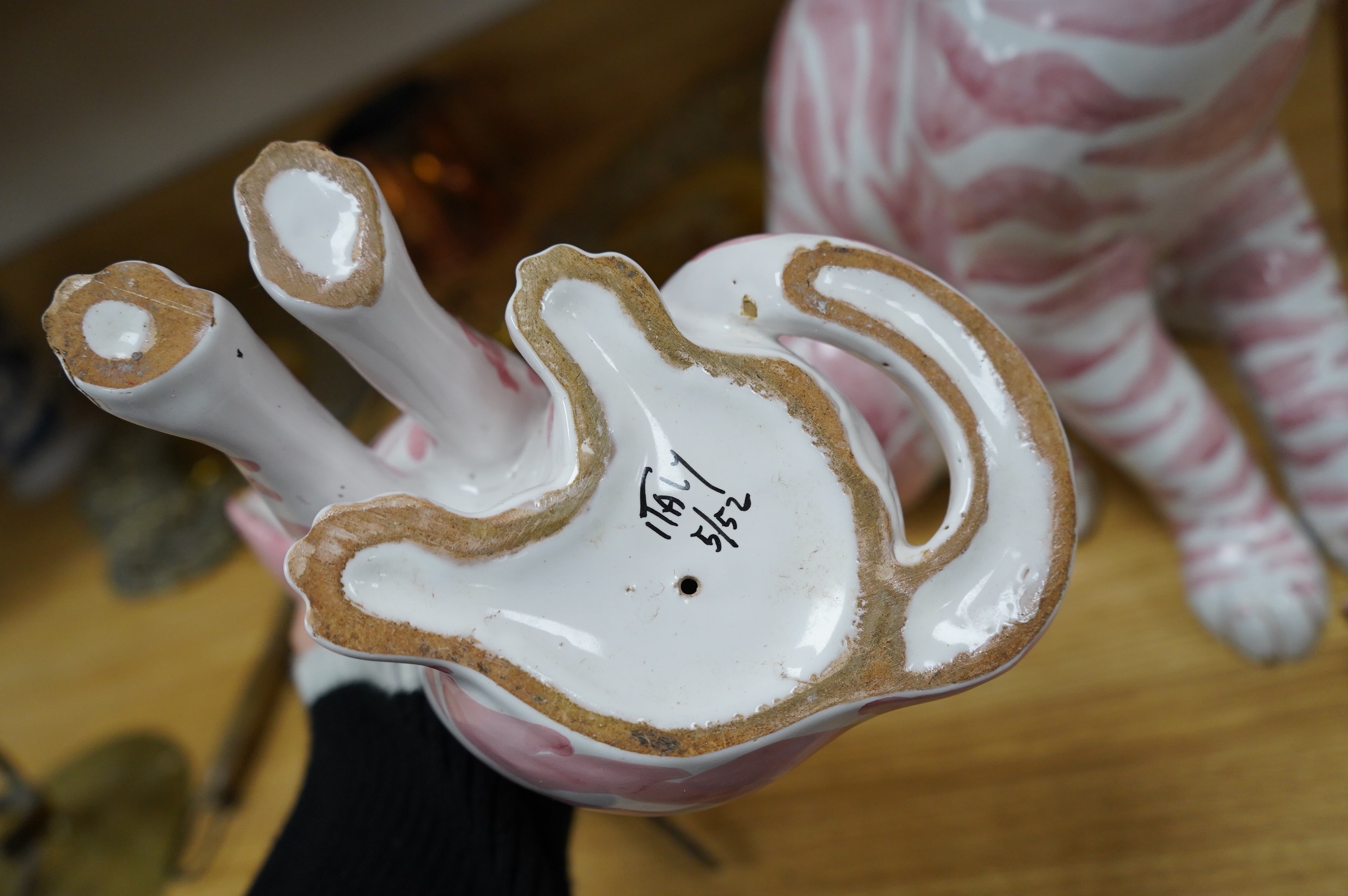 A large 1950's Italian pink maiolica seated cat and two smaller, largest 45cm. Condition - poor